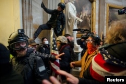 Pro-Trump protesters storm the U.S. Capitol to contest the certification of the 2020 U.S. presidential election results by the U.S. Congress, at the U.S. Capitol Building in Washington, Jan. 6, 2021.