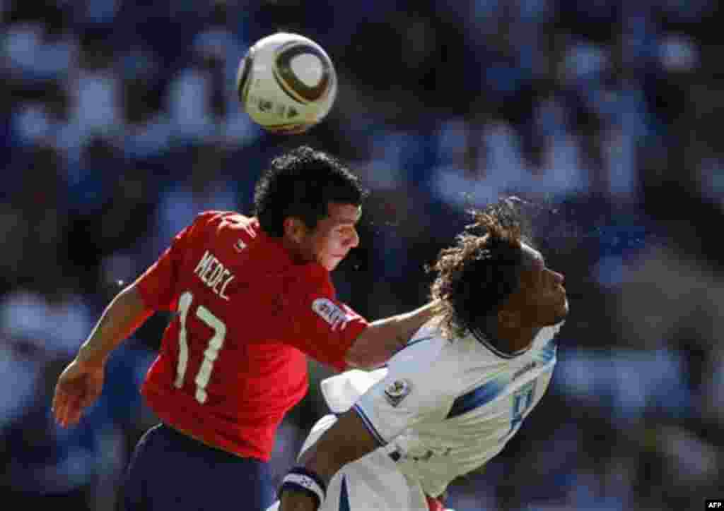 Chile's Gary Medel, left, and Honduras' Carlos Pavon head the ball during the World Cup group H soccer match between Honduras and Chile at Mbombela Stadium in Nelspruit, South Africa, Wednesday, June 16, 2010. (AP Photo/Ramon Espinosa)