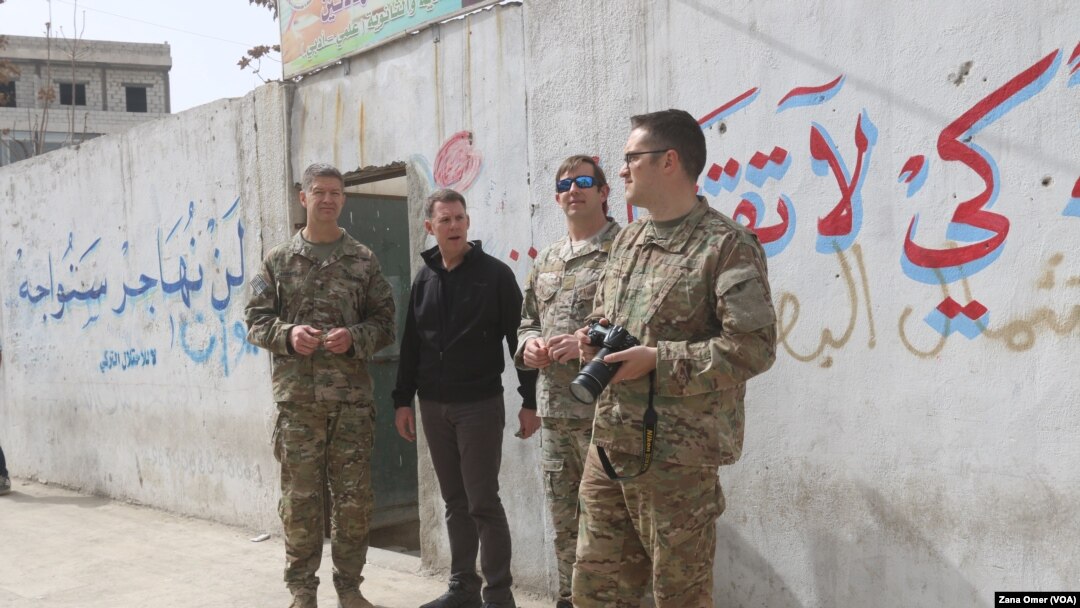U.S. military and diplomatic delegations tour the city of Manbij, Syria, March 22, 2018.