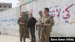 U.S. military and diplomatic delegations tour the city of Manbij, Syria, March 22, 2018.