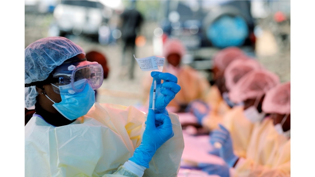 FILE - A health worker fills a syringe with Ebola vaccine before injecting it to a patient, in Goma, Democratic Republic of Congo, Aug. 5, 2019.