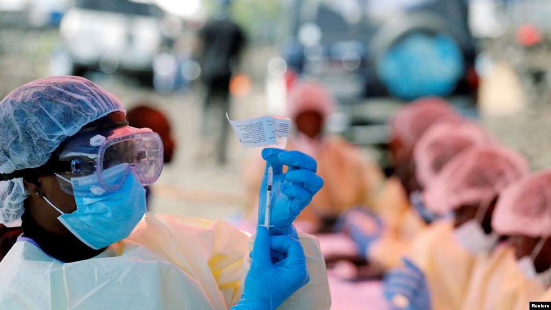 FILE - A health worker fills a syringe with Ebola vaccine before injecting it to a patient, in Goma, Democratic Republic of Congo, Aug. 5, 2019.