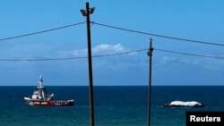 FILE — Open Arms rescue vessel tows a World Central Kitchen barge loaded with food towards Gaza, where there is risk of famine after five months of Israel's military campaign, in this handout image released March 15, 2024.