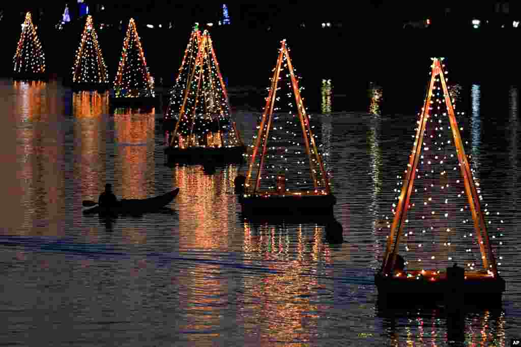 A kayaker paddles among holiday lights, Dec. 16, 2020, in Long Beach, California.