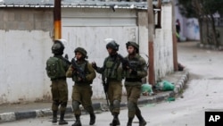 Members of Israeli armed forces patrol through the streets of the West Bank city of Jenin, Jan. 18, 2018. Israeli police say special forces killed a Palestinian gunman in the West Bank who allegedly killed an Israeli in a drive-by shooting earlier this month.