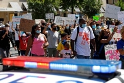 Protesters demonstrate Saturday, June 13, 2020, near the White House in Washington, over the death of George Floyd, who died after being restrained by Minneapolis police officers.