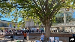 FILE - Club leaders at the University of North Carolina at Chapel Hill interact with students outside the student union in a quad known at "The Pit" on Monday, Oct. 24, 2022. 