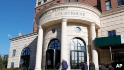 FILE - People enter U.S. District Court in White Plains, N.Y., Sept. 17, 2019.