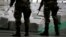 FILE - Police officers stand guard over seized cocaine. 