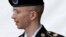 Army Pfc. Bradley Manning is escorted out of a courthouse in Fort Meade, Md. after receiving a verdict in his court martial, July 30, 2013.