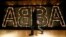 FILE - A man walks past the lit logo of the legendary Swedish pop group ABBA at "ABBA — The Museum" in Stockholm, May 6, 2013. 