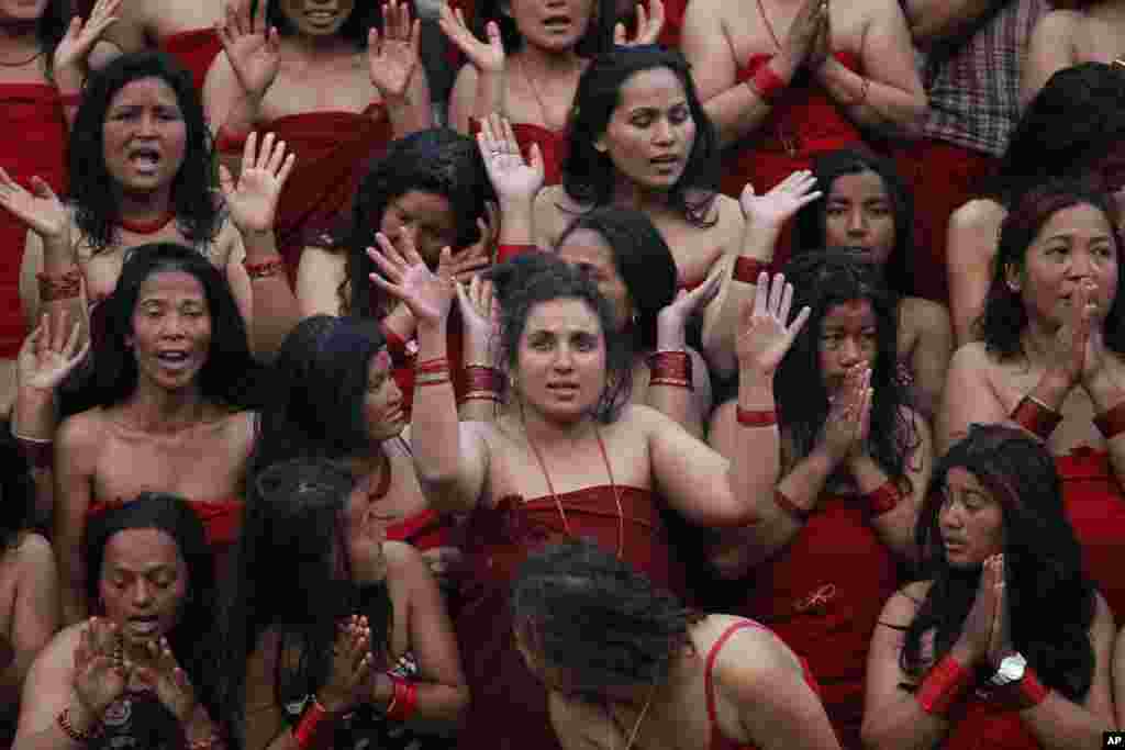 Nepalese Hindu women offer prayers as they get ready to take a holy dip in Bagmati River during the Madhav Narayan festival in Kathmandu, Nepal.