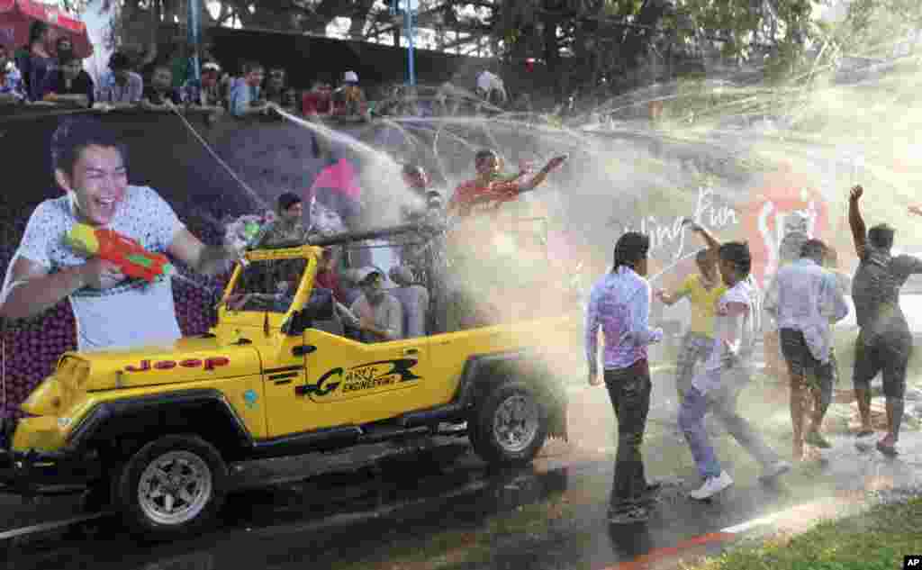 Revelers on a vehicle are sprayed with water during the traditional Thingyan celebrations in Rangoon, Burma. Burma celebrated its annual water festival, known as Thingyan, marking the start of the New Year according to the traditional Buddhist calendar.