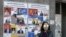 A woman walks past election posters on March 29, 2017 in Yerevan, ahead of April 2 parliamentary elections.