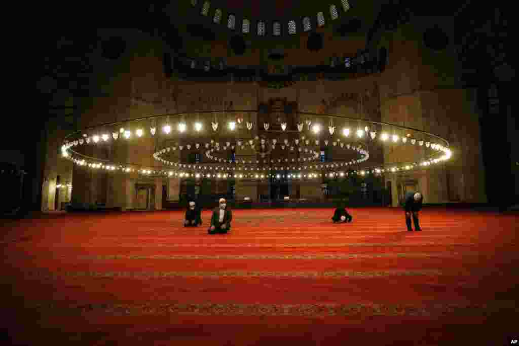 People wearing face masks offer the Eid al-Fitr prayer at historical Suleymaniye Mosque, in Istanbul, Turkey.
