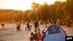 FILE - A Syrian family is seen in a tent on the beach at Menekse in Istanbul at sunset on July 28, 2019. 