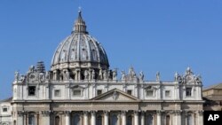 Tapestries portraying new proclaimed saints hang from the facade of St. Peter's Basilica during a canonization ceremony in St. Peter's Square at the Vatican.