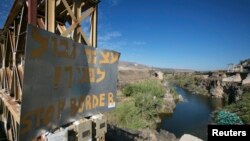 Warning sign on the Naharayim bridge spanning border of Israel and Jordan, north-eastern Israel, Oct. 22, 2014.