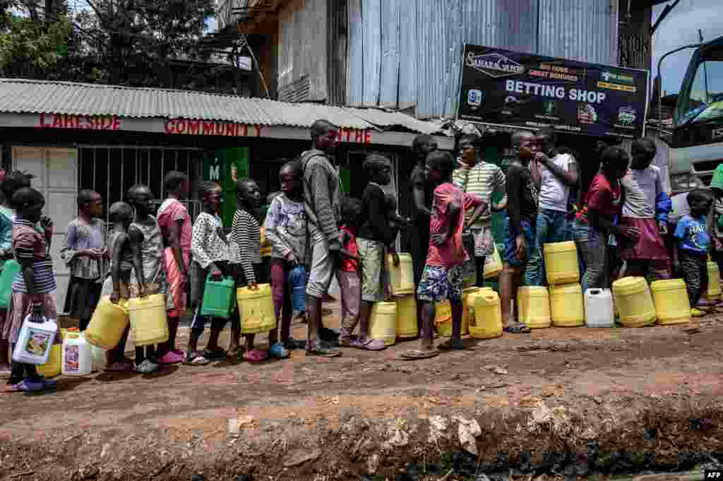 Children queue up to get water distributed by the Kenyan government, at the Kibera slum in Nairobi.