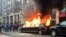 FILE - Protesters set a parked limousine on fire in downtown Washington during the inauguration of President Donald Trump, Jan. 20, 2017. 