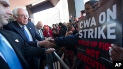 Democratic presidential candidate, Sen. Bernie Sanders, I-Vt., greets a CWA worker at a Verizon workers picket line, April 13, 2016, in the Brooklyn borough of New York.