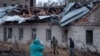 Residents walk at a site of a Russian missile strike, amid Russia's attack on Ukraine, in Dnipro, Ukraine, Nov. 21, 2024. 