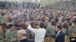 President Barack Obama greets military personnel who have recently returned from Afghanistan after speaking about the mission that resulted in the death of Osama bin Laden, at Fort Campbell, Kentucky, May 6, 2011
