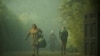 People carry their belongings following the spread of wildfires near Lautaro, Chile, Feb. 9, 2025 