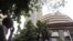 An Indian man watches a screen on the facade of the the Bombay Stock Exchange, Mumbai, India, June 18, 2012.