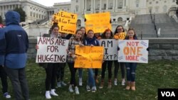 A group of high school students from the DMV area pose for a picture for reporters on the morning of March 14, 2018. They along with thousands of high school students around the country walked out of classes to protest gun violence in schools. 