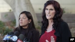 Cindy Lee Garcia, right, and attorney M. Cris Armenta hold a news conference before a hearing at Los Angeles Superior Court in Los Angeles, September 20, 2012.