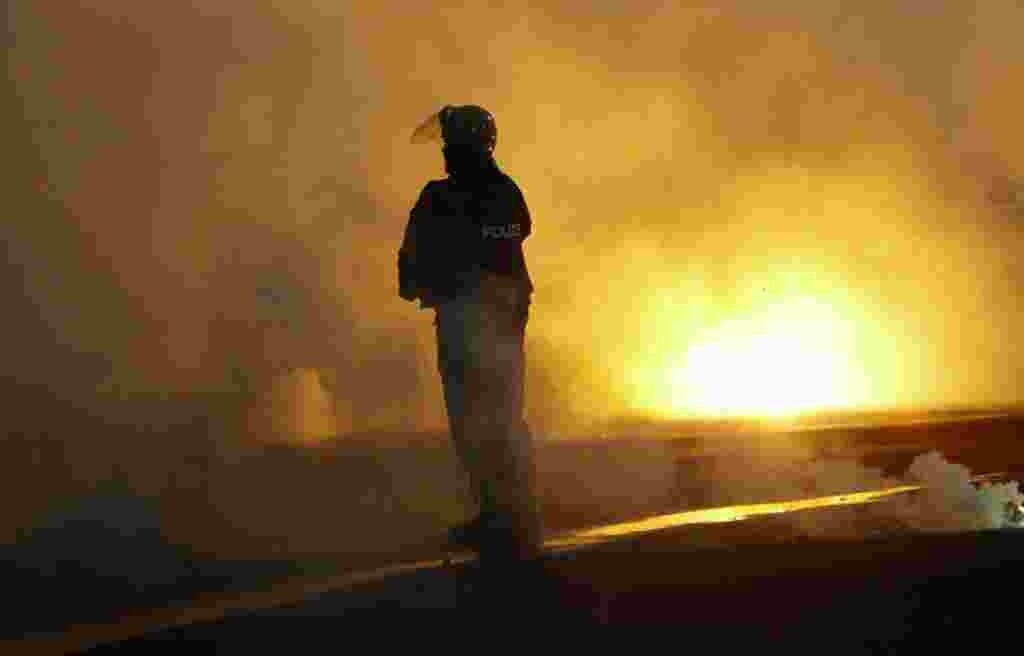 A policeman stands amidst thick smoke from flares during a Europa League Group soccer match between CSKA Sofia and Besiktas in Sofia December 2, 2010. (Oleg Popov/Reuters)