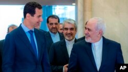 Photo released on the official Facebook page of Syrian Presidency shows Syrian President Bashar Assad (L) speaking with Iranian Foreign Minister Mohammad Javad Zarif in Damascus, Syria, April 16, 2019.