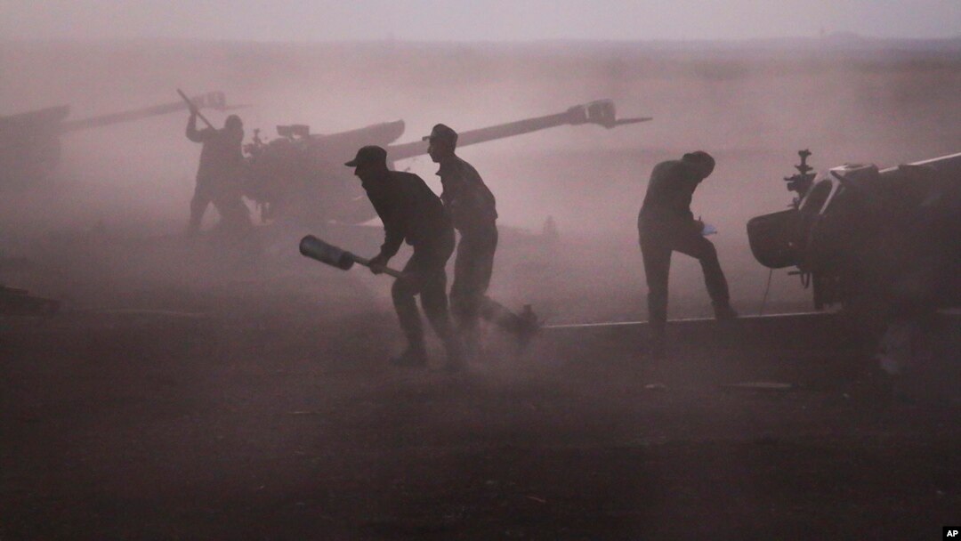 Syrian army personnel load howitzers near the village of Morek, Syria, Oct. 7, 2015.