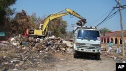 A backhoe performs flood recovery work in Muang Ake, Bangkok.