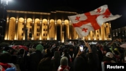 FILE - Demonstrators protest a bill on "foreign agents," near Georgian Parliament building, in Tbilisi, Georgia, May 13, 2024. 