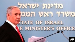 Prime Minister Benjamin Netanyahu approaches the podium to give a speech from his Jerusalem office, March 14, 2020. 