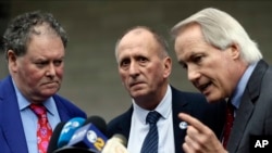 Cave explorer Vernon Unsworth, center, with his attorneys, Mark Stephens, left, and Lin Wood, take questions outside U.S. District Court, Dec. 6, 2019. Elon Musk did not defame Unsworth when he called him “pedo guy” in an angry tweet, a L.A. jury found. 