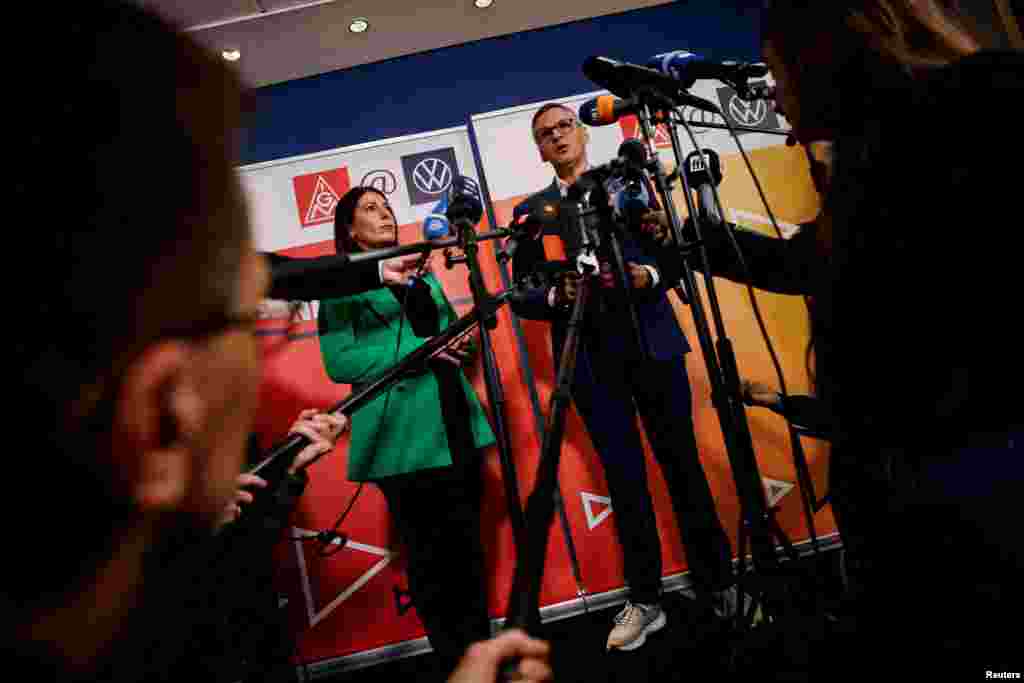 Daniela Cavallo, chairwoman of the general and group works council of Volkswagen AG, and Thorsten Groeger, district leader of Germany&#39;s metal worker union IG Metall, speak to the media before a second round of wage talks following VW&#39;s announcement to lay off thousands of employees and close down at least three VW plants, in Wolfsburg, Germany.