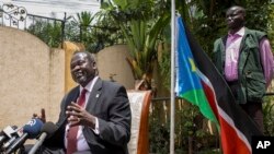 FILE - South Sudan's rebel leader Riek Machar, left, speaks to the media about the situation in South Sudan.