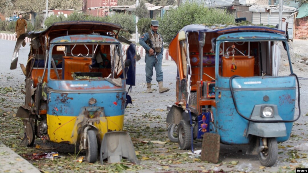 An Afghan policeman stands guard at the site of blast in Jalalabad city, Afghanistan November 25, 2016.