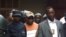 FrontPage Africa publisher Rodney Sieh (center) is being taken to jail (courtesy of FrontPage Africa)