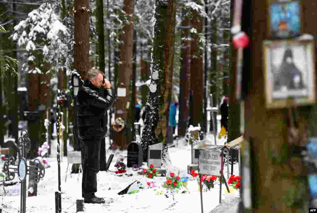 A man crosses himself at the memorial, where the victims of Soviet dictator Joseph Stalin&#39;s regime were buried in the woods on the outskirts of Saint Petersburg.