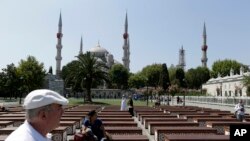 FILE - Tourists visit the Sultan Ahmed Mosque, also known as Blue Mosque, in Istanbul, Aug. 11, 2016. Tourism is a key sector and foreign-currency earner for Turkey, but numbers have dropped sharply as a result of a series of attacks in the country and an attempted coup in July.