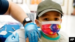 Oliver Estrada, de 5 años, recibe la primera dosis de la vacuna Pfizer COVID-19 en una clínica comunitaria de vacunas de Adelante Healthcare en la Escuela Primaria Joseph Zito, el 6 de noviembre de 2021, en Phoenix, EE. UU. 