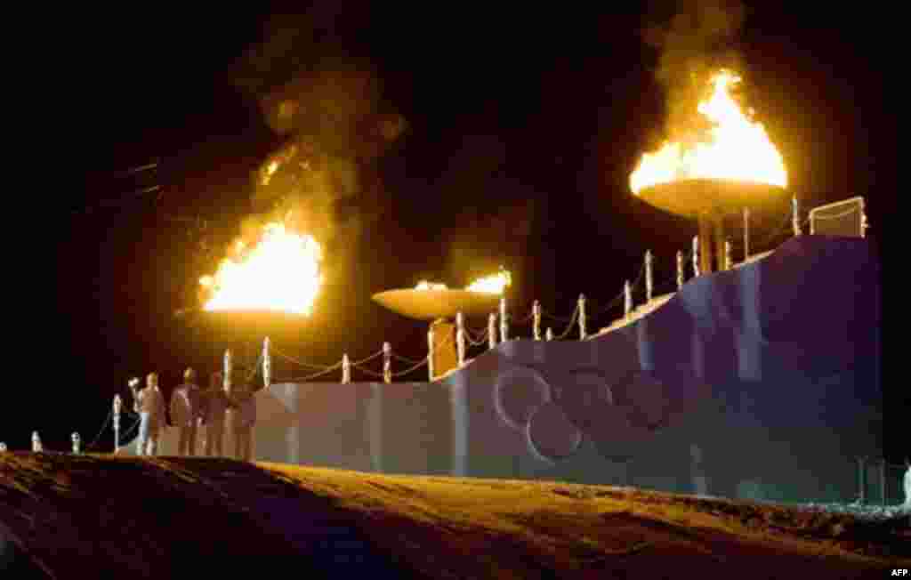 The Olympic cauldrons burn during the opening ceremony of the first winter Youth Olympic Games in Innsbruck, Friday, Jan. 13, 2012. (AP Photo/Kerstin Joensson)