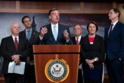 Sen. Mark Warner, D-Va., vice-chair of the Senate Intelligence Committee, is joined by fellow Democrats as he tells reporters that the Republicans have killed every piece of legislation the Democrats have crafted to protect elections, July 25, 2019.