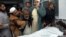 Pakistanis mourn next to the body of their relative killed in a suicide bombing, at a local hospital in Peshawar, Pakistan, Saturday, Dec. 22, 2012. 