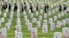 A tombstone is decorated at Levenworth National Cemetery on the eve of Memorial Day, May 27, 2018, in Leavenworth, Kansas.