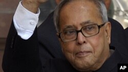 Indian Finance Minister Pranab Mukherjee (C) waves as he arrives at his office before leaving for Parliament to present Budget in New Delhi, File.